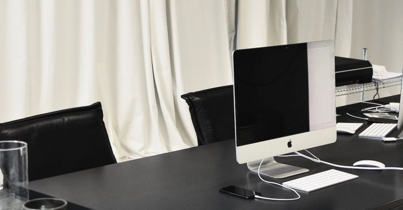 Plumbing System - Black and white of contemporary computer placed on table in simple contemporary workplace of office