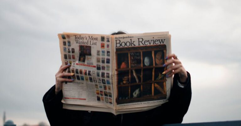 Reviews - Person Holding White and Brown Newspaper