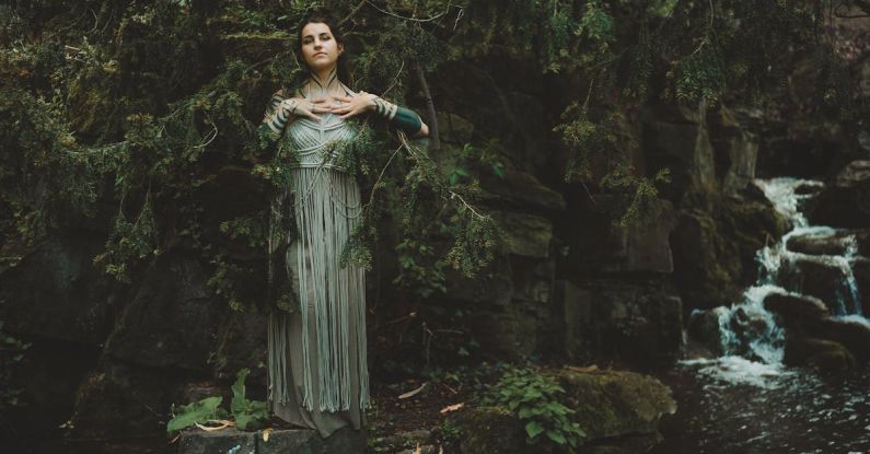 Water Filtration - Woman in a Dress Standing on a Rock near a Waterfall